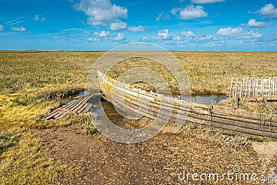 Rustic old boat left to decay on Salt Marshes between Blakeney and Cley Stock Photo