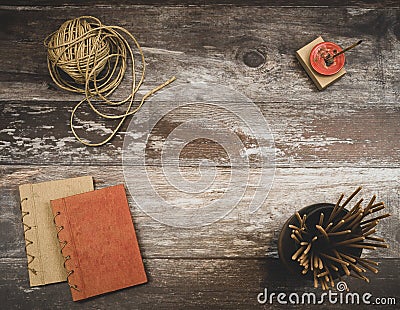 Rustic old vintage wood table with burning incense, incense sticks, natural twine and two small handmade books, with copyspace Stock Photo