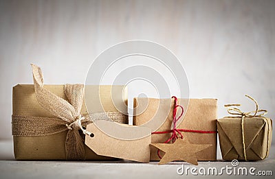 Rustic retro gifts, present boxes with tag. Christmas time, eco paper wrap. Stock Photo