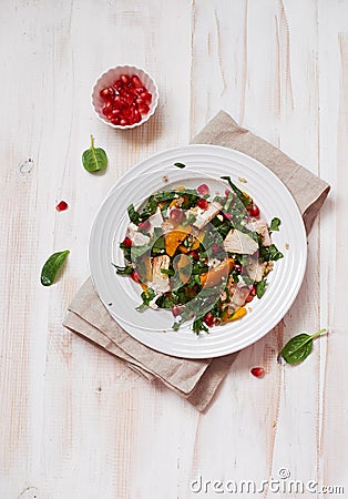 Rustic salad with pumpkin, chicken , spinach and pomegranate seeds Stock Photo