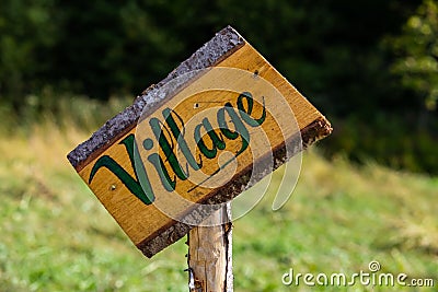 Rustic skewed wooden village signpost Stock Photo