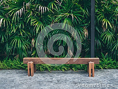 Rustic solid railway sleeper wooden bench on concrete floor Stock Photo