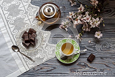 Useful, hot herbal tea, candy and flowering almond twigs Stock Photo