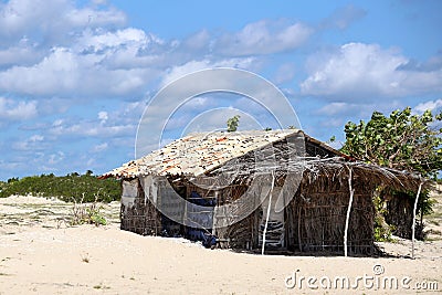Rustic and very poor house on the beach. Poor fisherman`s house. Rustic wattle and daub and adobe construction Stock Photo