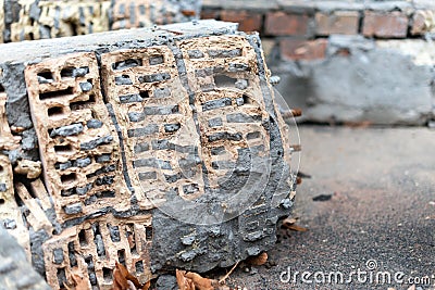 Rustic, weathered bricks embedded in concrete. The macro perspective highlights the rough texture, cracks, and intricate patterns Stock Photo