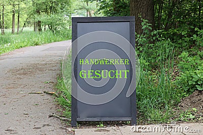 A rustic, weathered old vintage school blackboard with the words Handyman Wanted Editorial Stock Photo