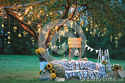 Rustic wedding photo zone. Hand made wedding decorations includes Photo Booth, wooden barrels and boxes, lanterns, suitcases and w Stock Photo