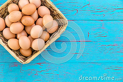 Rustic wicker basket with farm fresh brown eggs Stock Photo