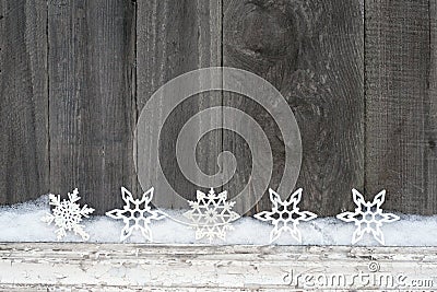 Rustic winter background with glitter snowflakes and snow on wooden texture. Christmas and New Year greeting card background Stock Photo