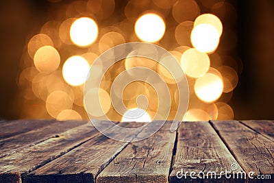 Rustic wood table in front of glitter gold bright bokeh lights Stock Photo