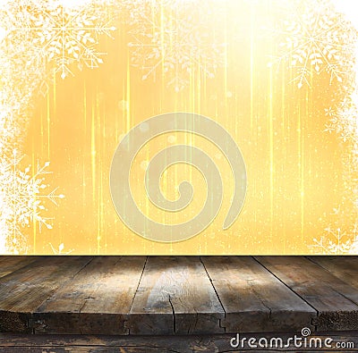 Rustic wood table in front of glitter silver and gold bright bokeh lights with snowflacke overlay Stock Photo