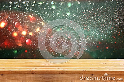 Rustic wood table in front of glitter silver, green, blue and gold bright bokeh lights Stock Photo