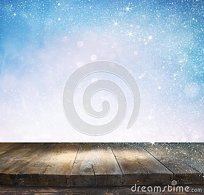 Rustic wood table in front of glitter silver and white bright bokeh lights Stock Photo