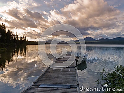 Rustic wooden float dock jetty boat tranquil lake Stock Photo