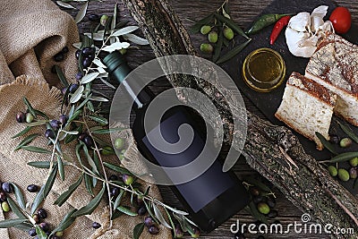 Olive oil, bread and olives on rustic wooden background Stock Photo