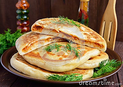 Rustic yeast cakes with cabbage in a clay bowl. Stock Photo