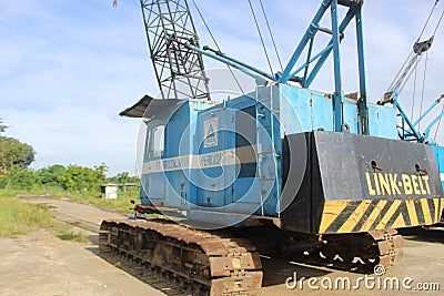 Rusting Antique Blue Crane with Blue Sky Editorial Stock Photo
