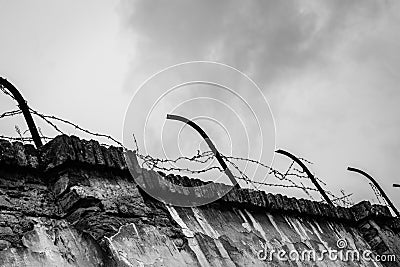 Rusting barbwired wall in Terezin concentration camp - Black and White Editorial Stock Photo