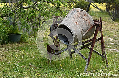 Rusting old cement mixer left to corrode. Stock Photo