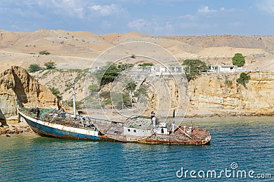 Rusting ship wreck stranded at beach of Angola`s Namib coast Stock Photo