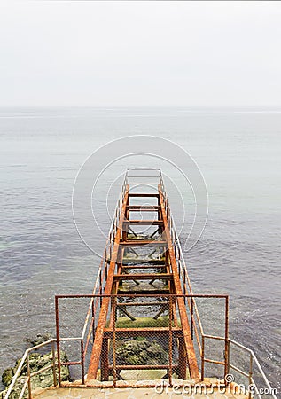 Rusty abandoned pier in sea Stock Photo
