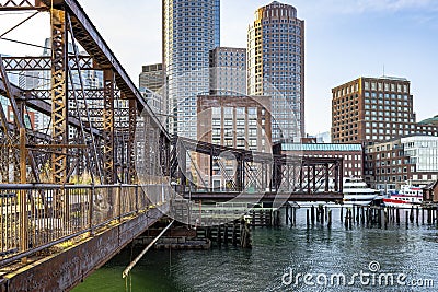 Rusty abandoned truss bridge and skyscrapers of down town in the bay on the modern waterfront in Boston in New England Stock Photo