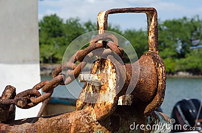 Rusty anchor roller and chain Stock Photo