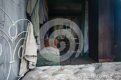 Rusty bedframe and mattress inside a home in Bodie Ghost Town in California Stock Photo