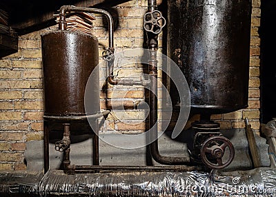 Rusty boiler room pipes. Old metal boiler generating heating and delivering it to home through pipeline. Hot water or gas is being Stock Photo
