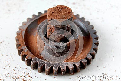 Rusty bolt, nut and gear wheel made of chocolate isolated on white background Stock Photo