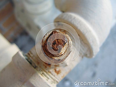 Rusty bolt on water pipe Stock Photo