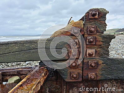 Rusty bolts and old wood. Old beach groyne detail. Stock Photo