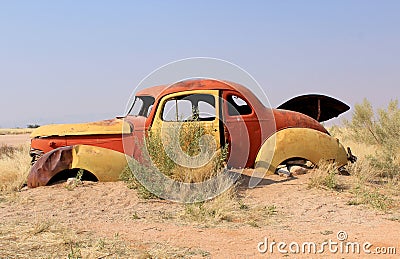 Rusty car wreck at last station in Namib desert Stock Photo