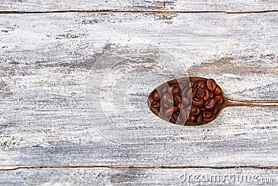 Rusty coffee spoon, wooden background. Stock Photo