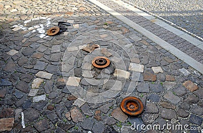 Only rusty discs remained in the parking lot after the car`s brakes were repaired. Someone ruthlessly put down the parts and drove Stock Photo
