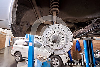 Rusty drum brakes, rear on car. Change the old to new brake disc on car in a garage. Auto mechanic repairing Stock Photo