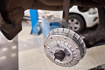 Rusty drum brakes, rear on car. Change the old to new brake disc on car in a garage. Auto mechanic repairing Stock Photo