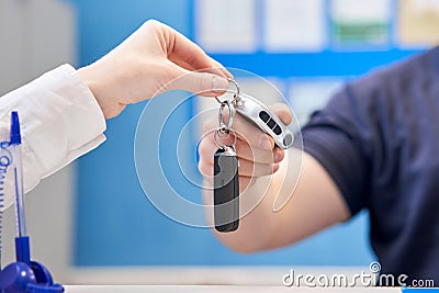 Rusty drum brakes, rear on red car. Change the old to new brake disc on car in a garage. Auto mechanic repairing Stock Photo