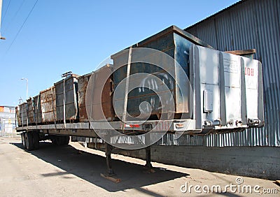 Old garbage dumpsters on flatbed trailer Stock Photo