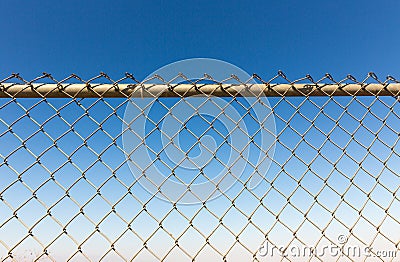 Rusty fence rabitz on the background of sky. Stock Photo