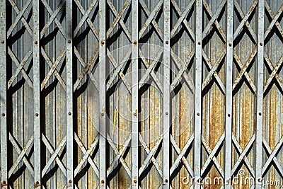 Rusty grey Steel folding entry door detail background with caste Stock Photo