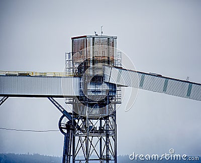 A rusty, grungy silo at a wharf against a gray sky. Taken in Seattle, Washington. Stock Photo