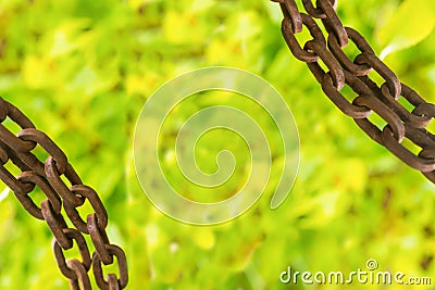 Rusty industrial design frame chain located at the corners on a blurry bright green background with copy space Stock Photo