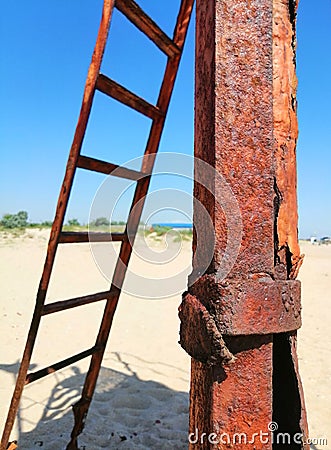 Rusty iron and stairs on the sand Stock Photo