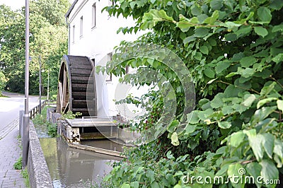 Rusty iron wheel of old mill water.Water Wheel - motion blur on wheel. Stock Photo