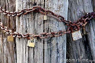 Rusty love locks on an old pole, a romantic gesture of undying love Stock Photo