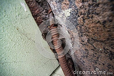 Rusty metal corrugated hose with wire covered in cobweb with dust Stock Photo