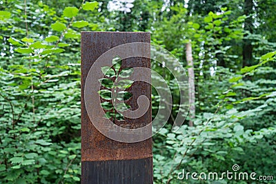 Rusty metal flower sculptures in forest Stock Photo