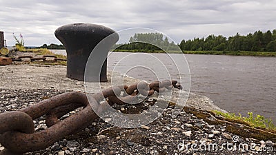 Rusty metal mooring bollard for a large ship. Anchorage on the Wharf for ships. Stock Photo