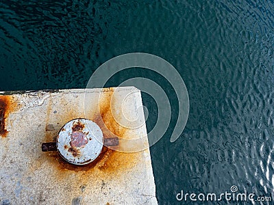 A rusty mooring bolard in two colours Stock Photo